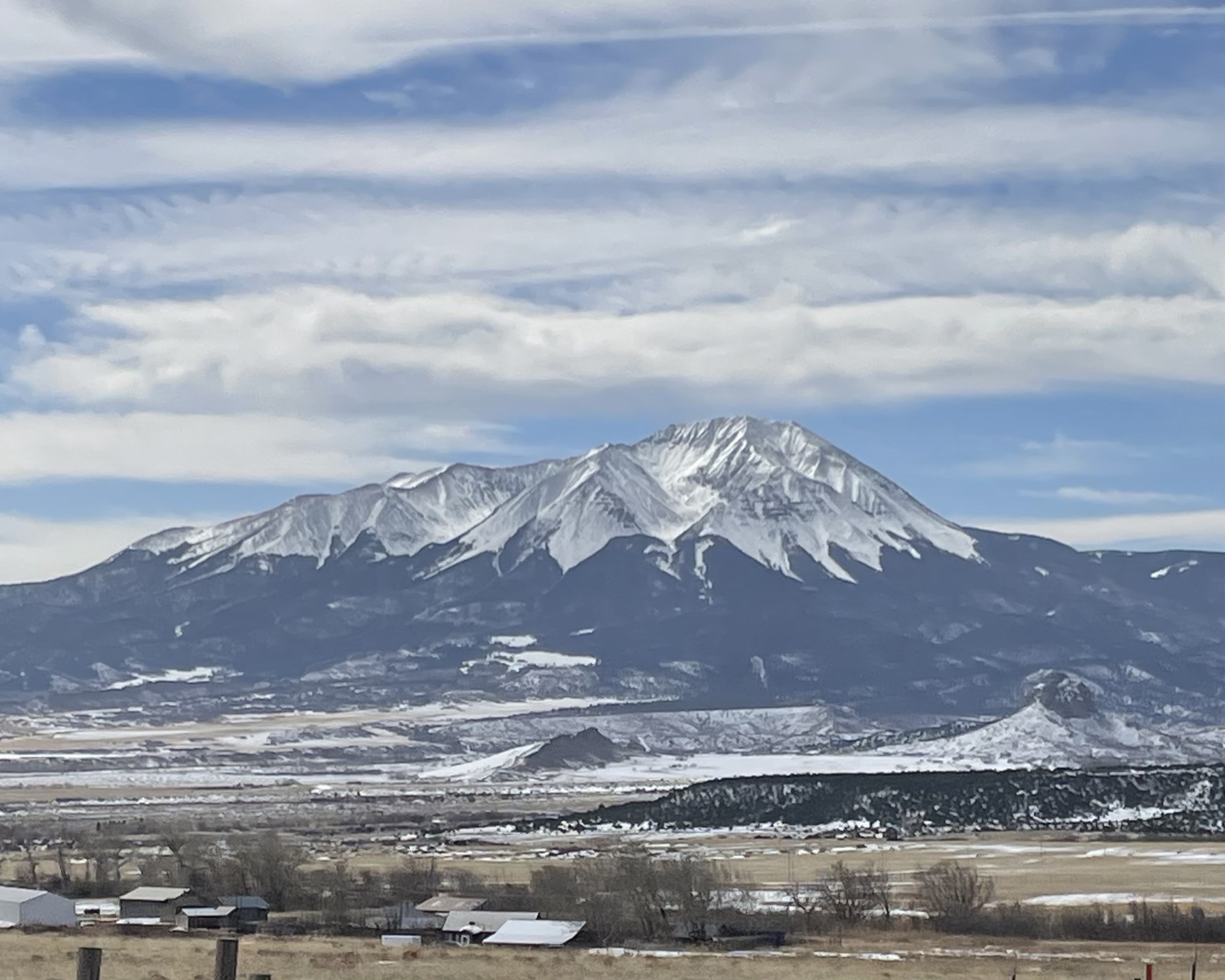 A snow-capped peak above a San Luis Valley ranch in winter